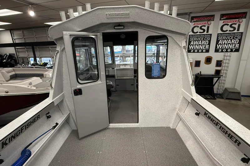 Slide: The Image of Interior view of 2025 KingFisher Escape HT boat in showroom with award plaques. - 4