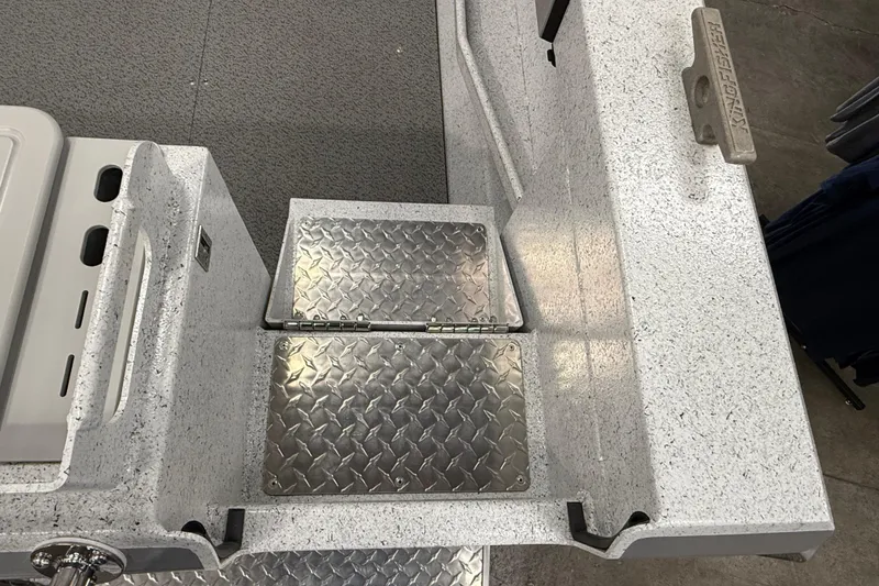 Slide: The Image of KingFisher 2025 Escape HT boat deck with diamond plate hatch and textured surface. - 5