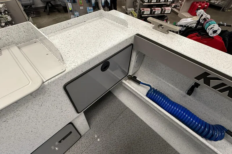 Slide: The Image of Interior of 2025 KingFisher Escape HT boat with storage and blue hose. - 7