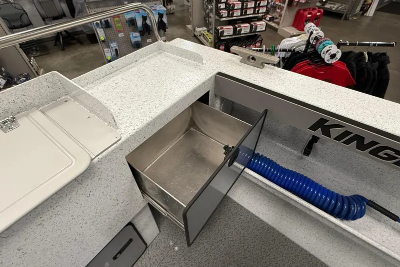 Slide: The Image of Interior view of a 2025 KingFisher Escape HT boat with storage compartment and blue hose. - 8