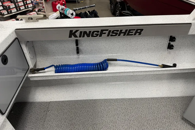Slide: The Image of Interior view of a 2025 KingFisher Escape HT boat with coiled blue hose. - 9