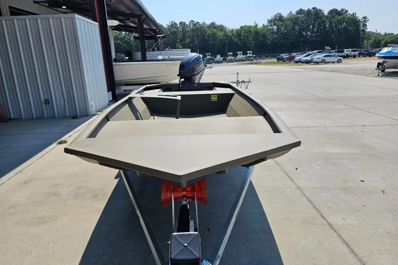 Slide: The Image of 2026 G3 Gator Tough 1652 VBW boat on trailer in outdoor storage area. - 2