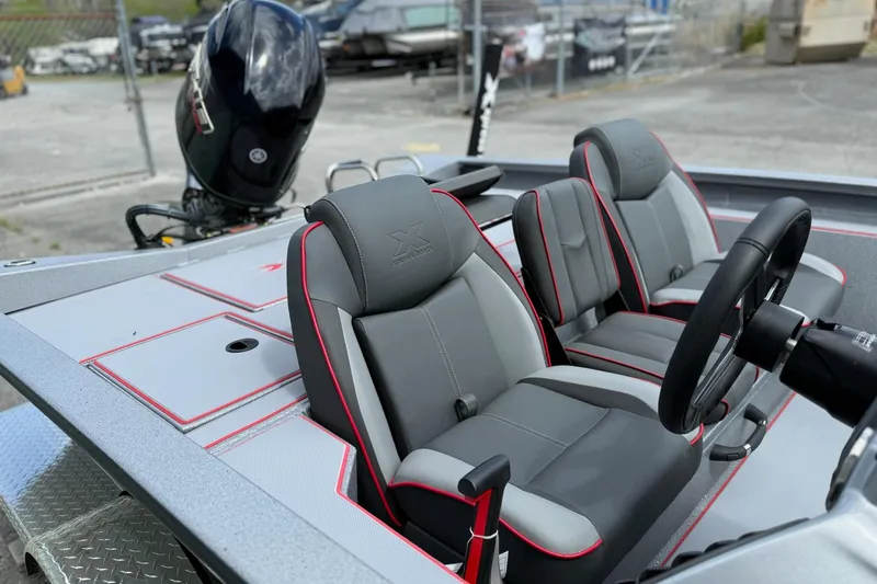 Slide: The Image of 2026 Xpress H18C Crappie boat interior with dual seats and steering wheel. - 10