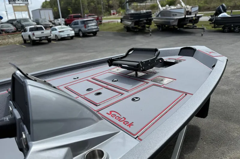 Slide: The Image of 2026 Xpress H18C Crappie boat with SeaDek flooring in a parking lot. - 11