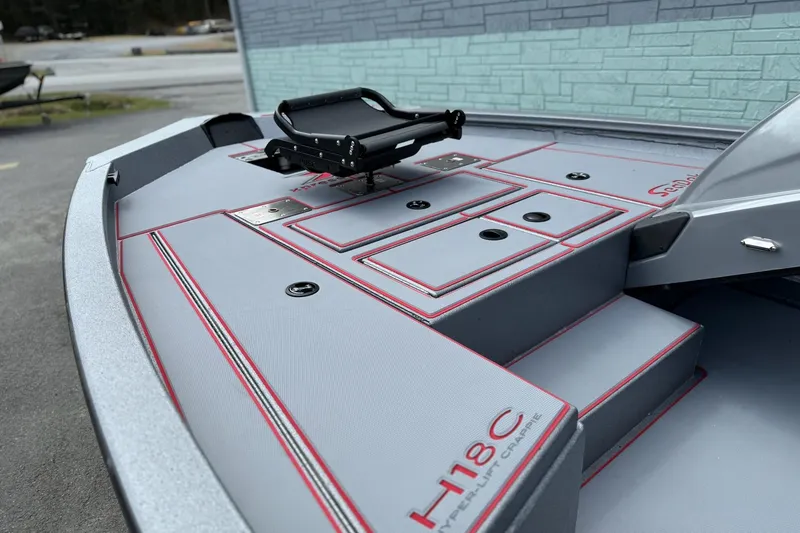 Slide: The Image of 2026 Xpress H18C Crappie boat deck with storage compartments and seating. - 4