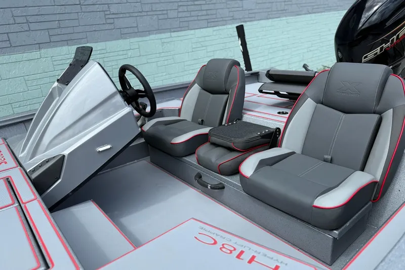Slide: The Image of 2026 Xpress H18C Crappie boat interior with gray and red seating. - 5