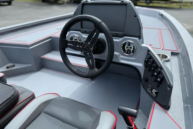 Slide: The Image of 2026 Xpress H18C Crappie boat interior with steering wheel and control panel. - 9