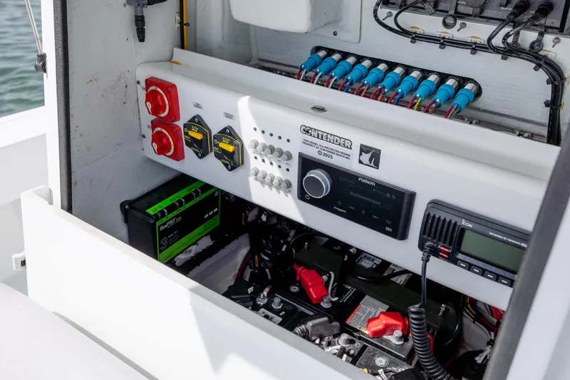 Slide: The Image of Electrical panel of 2024 Contender 23 Bay boat, featuring switches and wiring components. - 19