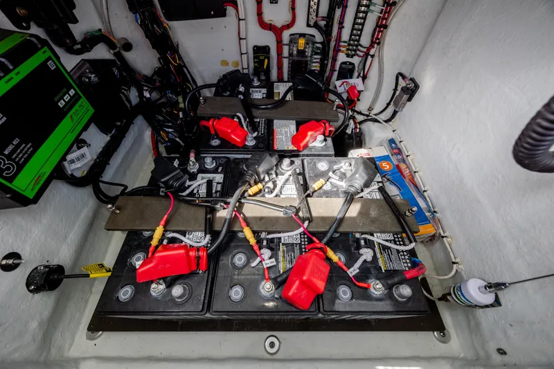 Slide: The Image of Battery compartment of 2024 Contender 23 Bay boat, showcasing wiring and connections. - 20