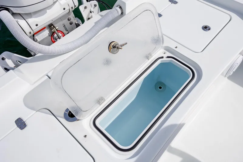 Slide: The Image of 2024 Contender 23 Bay boat with open storage compartment on deck. - 22