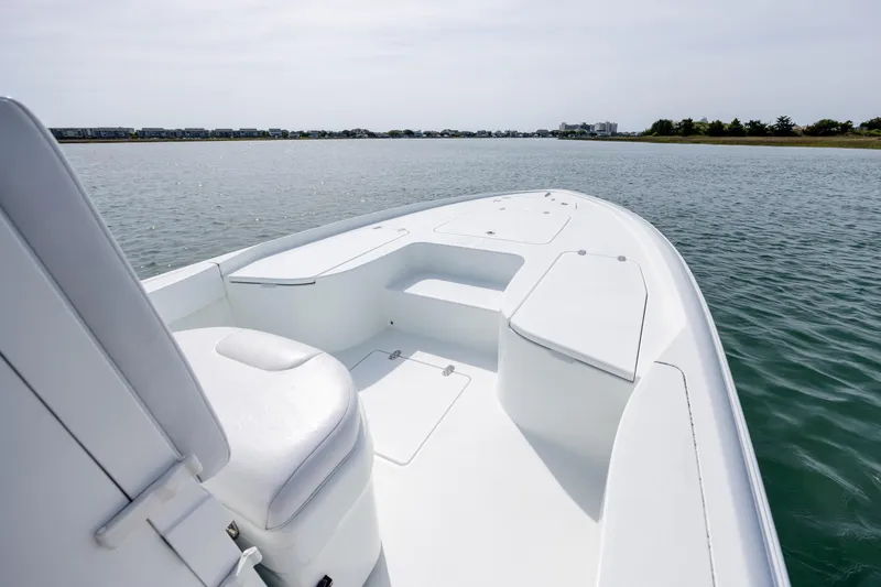 Slide: The Image of 2024 Contender 23 Bay boat on calm water, showcasing sleek design and spacious deck. - 25