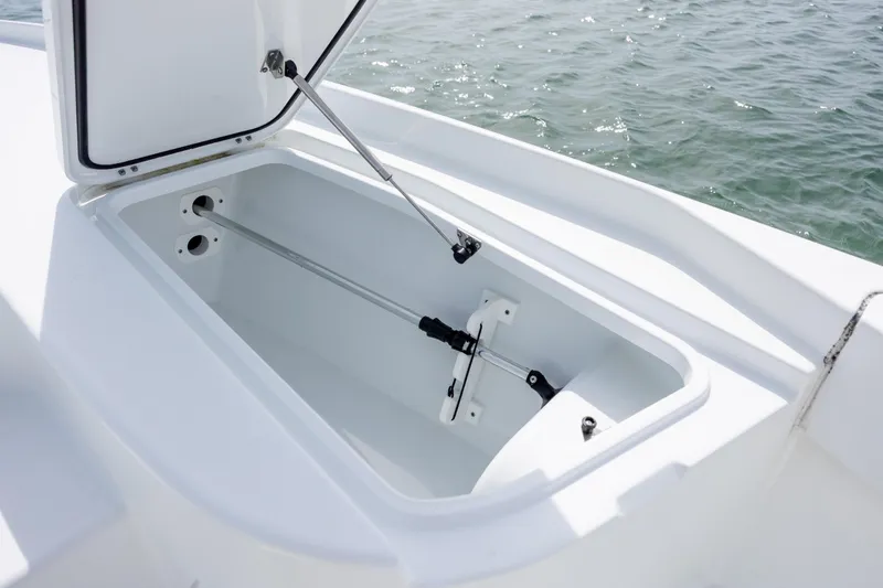 Slide: The Image of Open storage compartment on 2024 Contender 23 Bay boat, with ocean in background. - 31