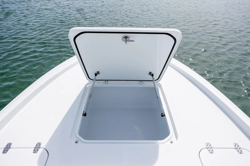 Slide: The Image of Open storage compartment on 2024 Contender 23 Bay boat, floating on water. - 33