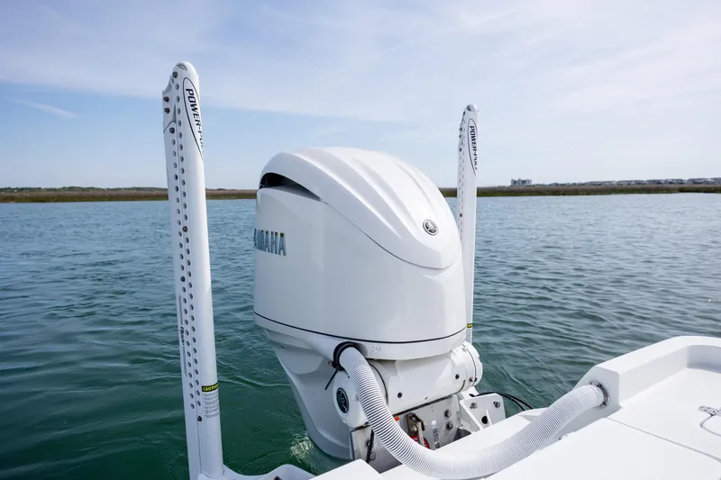 Slide: The Image of 2024 Contender 23 Bay boat with Yamaha outboard motor on calm water. - 36