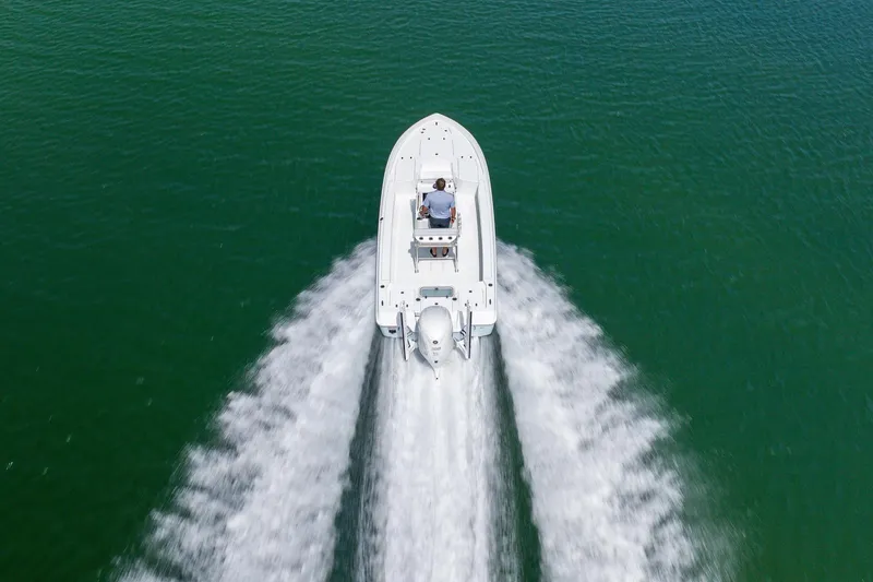 Slide: The Image of 2024 Contender 23 Bay boat cruising on open water, aerial view. - 43