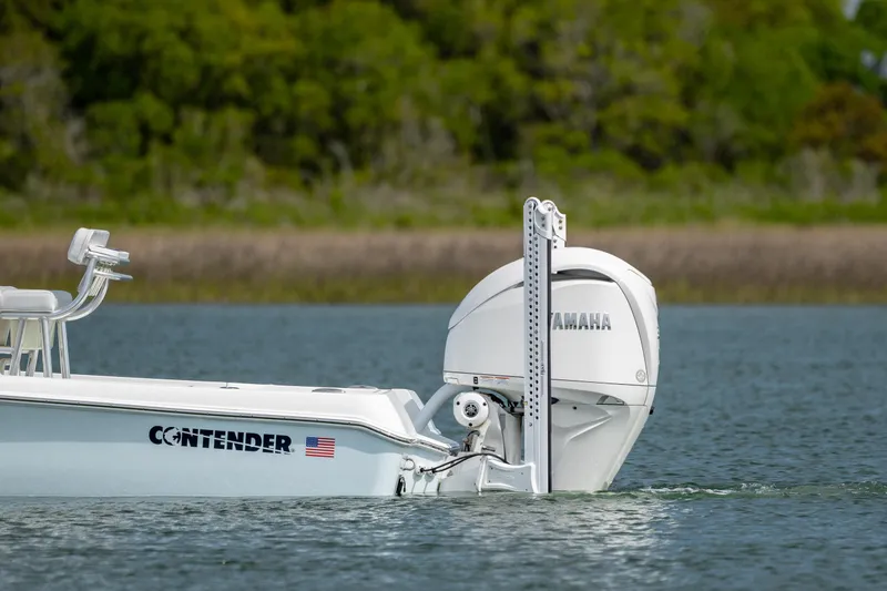 Slide: The Image of 2024 Contender 23 Bay boat with Yamaha engine on calm water. - 8