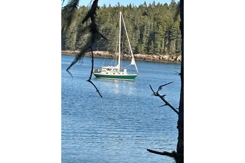 Slide: The Image of Compact kitchen area in a 1998 Peter Scott Chuck Paine 30 sailboat, featuring stove and storage. - 9