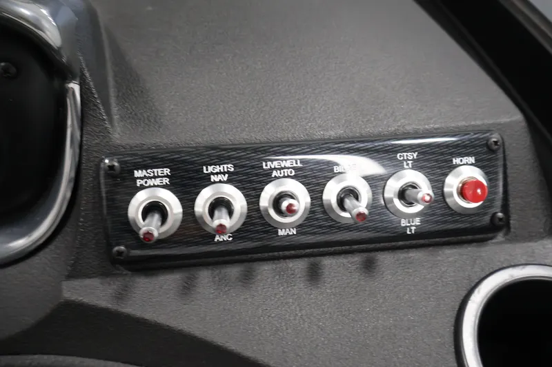 Slide: The Image of Control panel of 2026 Crestliner 2050 Authority boat with switches for power, lights, and horn. - 34