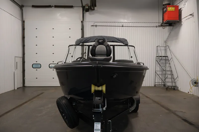 Slide: The Image of 2026 Crestliner 2050 Authority boat in a garage, front view. - 12