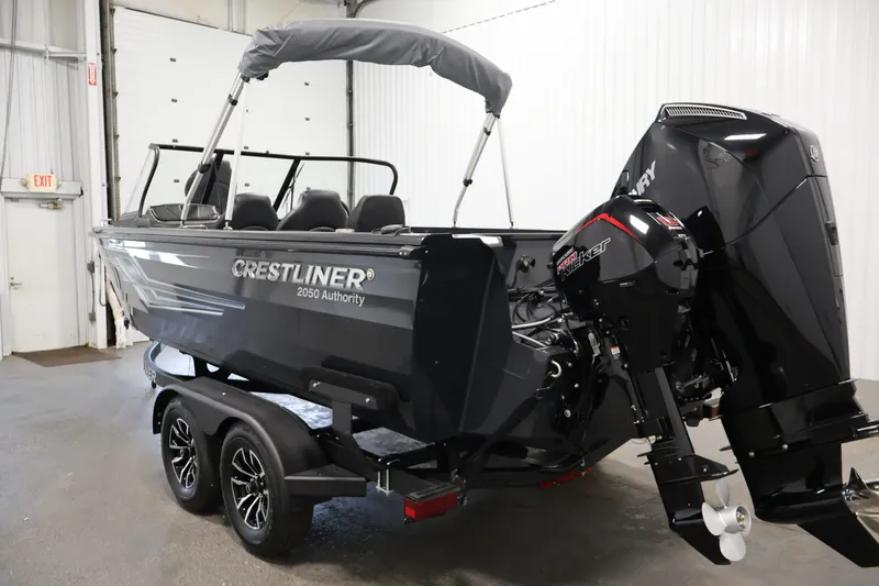 Slide: The Image of 2026 Crestliner 2050 Authority boat with outboard motor in a showroom. - 17