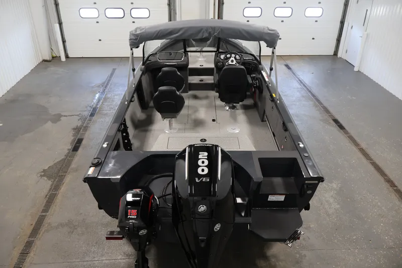 Slide: The Image of 2026 Crestliner 2050 Authority boat with Mercury 200 V6 engine in a garage. - 20