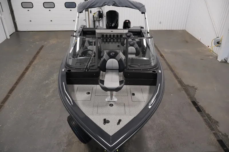 Slide: The Image of 2026 Crestliner 2050 Authority boat in a garage, showcasing sleek design and spacious interior. - 19