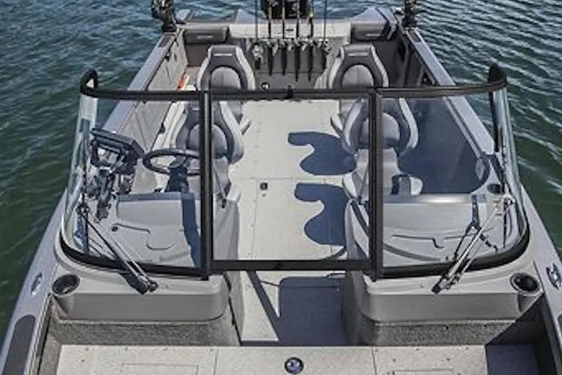 Slide: The Image of 2026 Crestliner 2050 Authority boat interior with seating and steering, on calm water. - 4