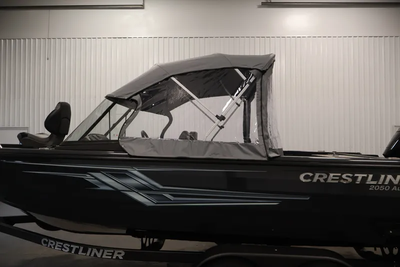 Slide: The Image of 2026 Crestliner 2050 Authority boat with canopy in a showroom setting. - 58