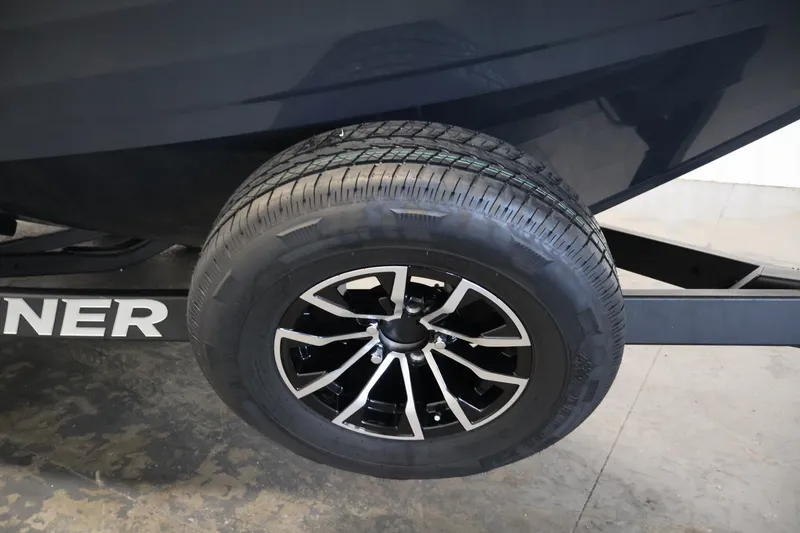 Slide: The Image of Trailer wheel of 2026 Crestliner 2050 Authority boat, featuring sleek black and silver design. - 54