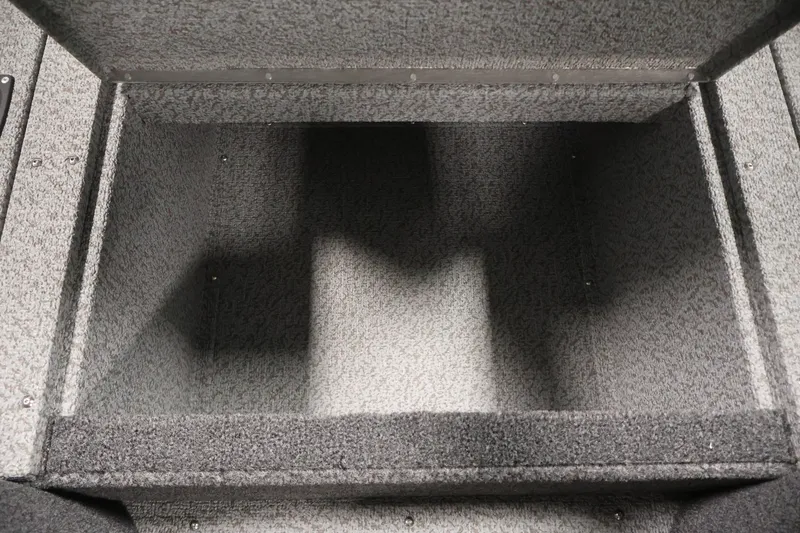 Slide: The Image of Open storage compartment in 2026 Crestliner 2050 Authority boat, carpeted interior. - 28