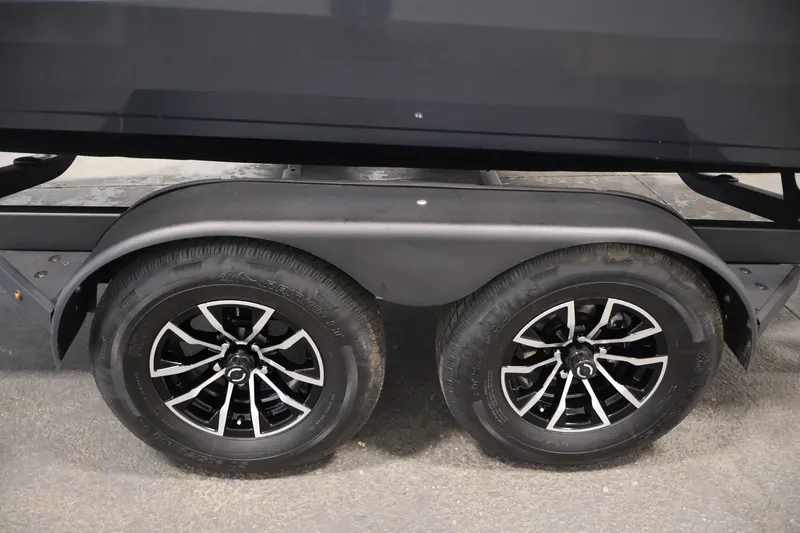 Slide: The Image of Trailer wheels of 2026 Crestliner 2050 Authority boat, featuring sleek black rims. - 56