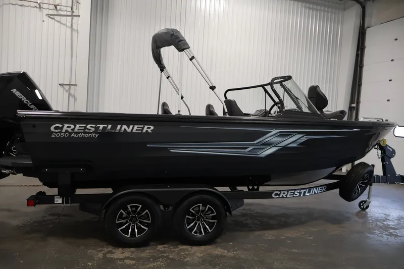 Slide: The Image of 2026 Crestliner 2050 Authority boat on trailer in indoor setting. - 14
