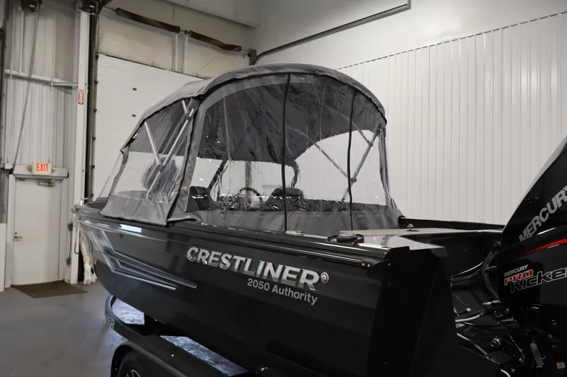 Slide: The Image of 2026 Crestliner 2050 Authority boat with canopy in indoor setting. - 59