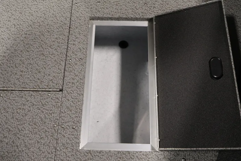 Slide: The Image of Open storage compartment on 2026 Crestliner 2050 Authority boat, featuring textured flooring. - 26
