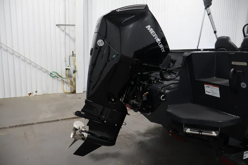 Slide: The Image of 2026 Crestliner 2050 Authority boat with Mercury outboard motor in a garage setting. - 48