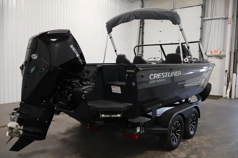 Slide: The Image of 2026 Crestliner 2050 Authority boat with Mercury engine in a showroom. - 15