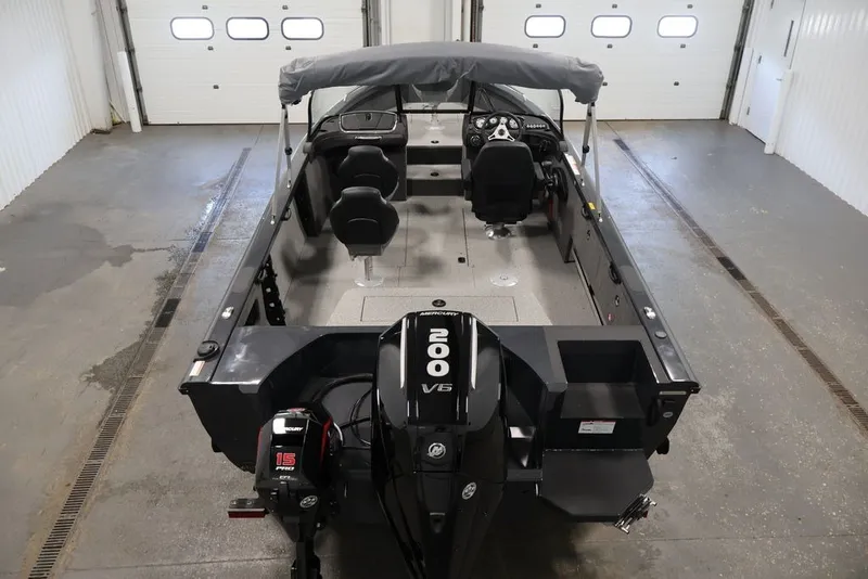Slide: The Image of 2027 Crestliner 2050 Authority boat with dual motors in a garage setting. - 24