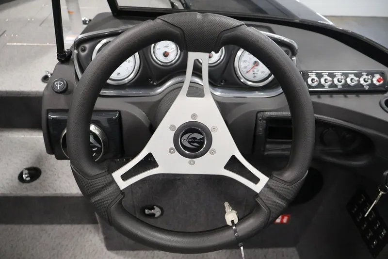 Slide: The Image of Steering wheel and dashboard of 2027 Crestliner 2050 Authority boat, featuring gauges and controls. - 29