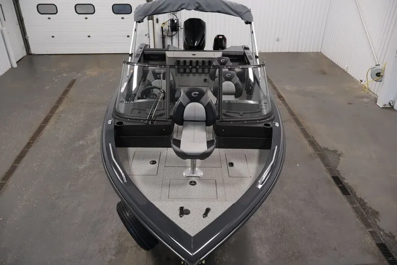 Slide: The Image of 2027 Crestliner 2050 Authority boat in a garage, showcasing sleek design and seating. - 21