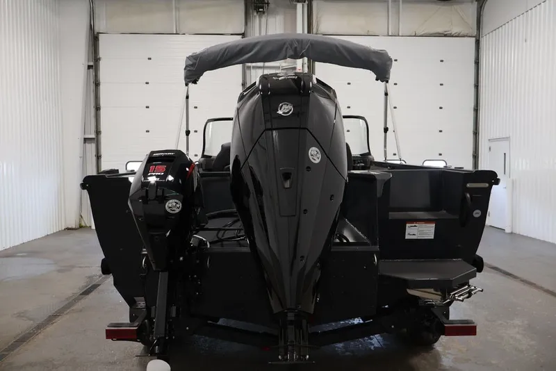 Slide: The Image of 2027 Crestliner 2050 Authority boat with dual outboard motors in a garage setting. - 17