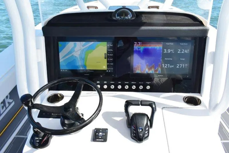Slide: The Image of Helm of 2025 Jupiter 32 FS boat with advanced navigation displays and controls. - 10