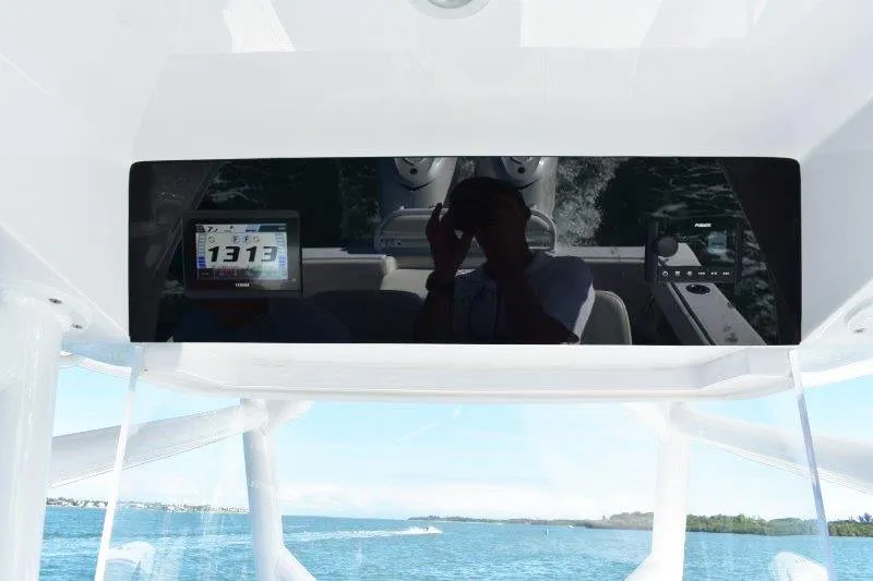 Slide: The Image of 2025 Jupiter 32 FS boat dashboard with digital display on open water. - 11