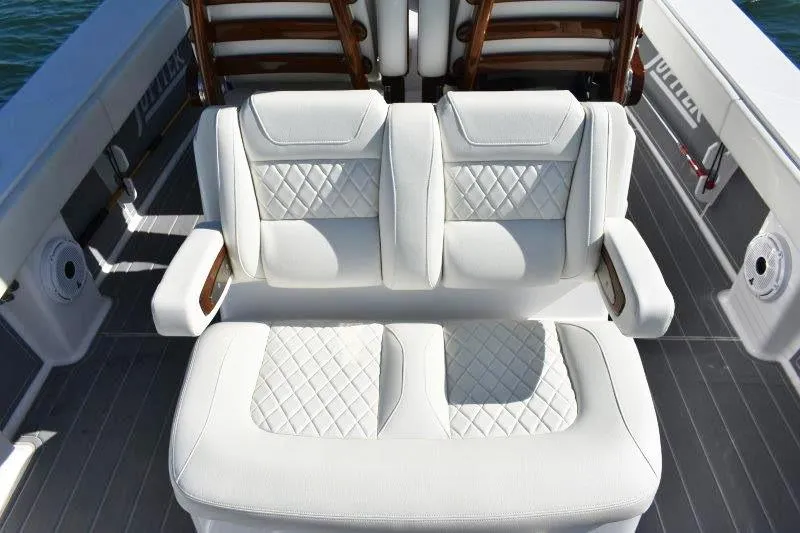 Slide: The Image of Luxurious seating on 2025 Jupiter 32 FS boat with quilted white upholstery. - 12