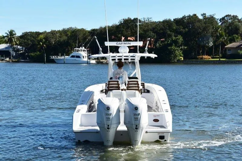 Slide: The Image of 2025 Jupiter 32 FS boat cruising on a calm lake with twin engines. - 2