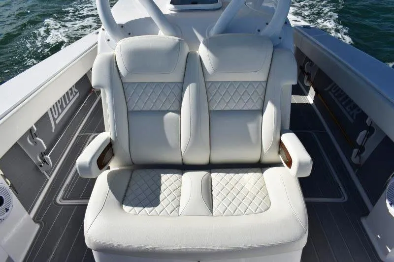 Slide: The Image of Luxurious seating on 2025 Jupiter 32 FS boat with quilted white upholstery. - 7