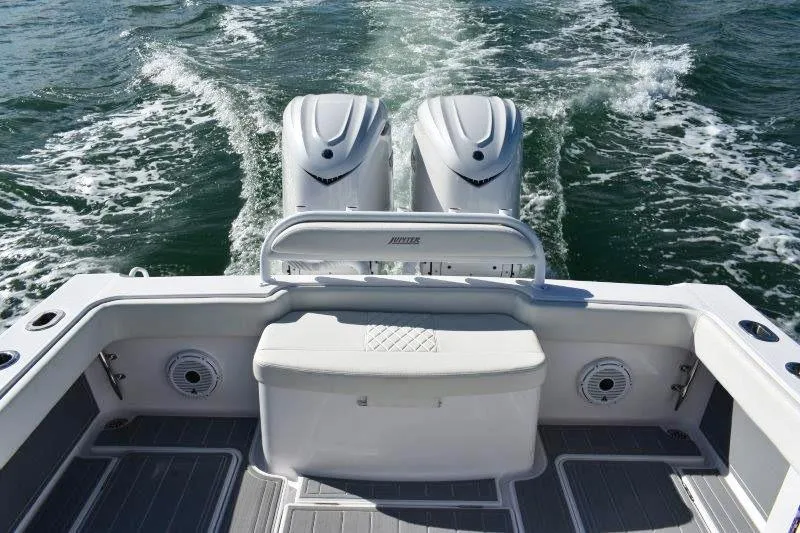 Slide: The Image of 2025 Jupiter 32 FS boat with dual engines cruising on open water. - 8