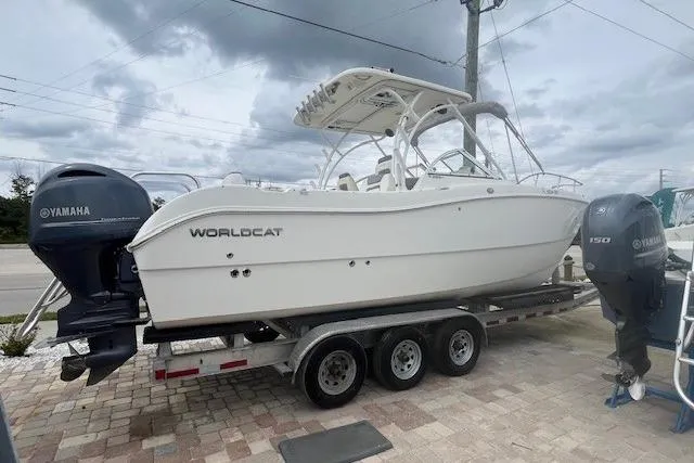 The Image of 2017 World Cat 255 DC boat on trailer with Yamaha engines, parked outdoors. - 1
