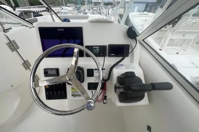 Slide: The Image of Helm of 2017 World Cat 255 DC boat with steering wheel and navigation controls. - 7