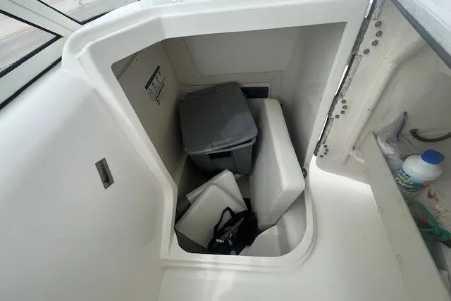 Slide: The Image of Storage compartment in a 2017 World Cat 255 DC boat with cushions and a storage bin. - 8