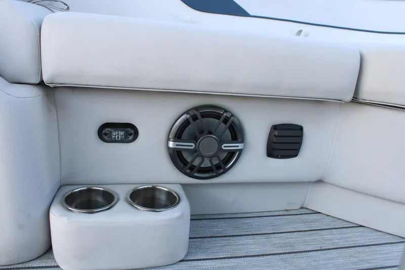 Slide: The Image of 2024 SunCatcher Select 22RC boat interior with speaker, cup holders, and light. - 12